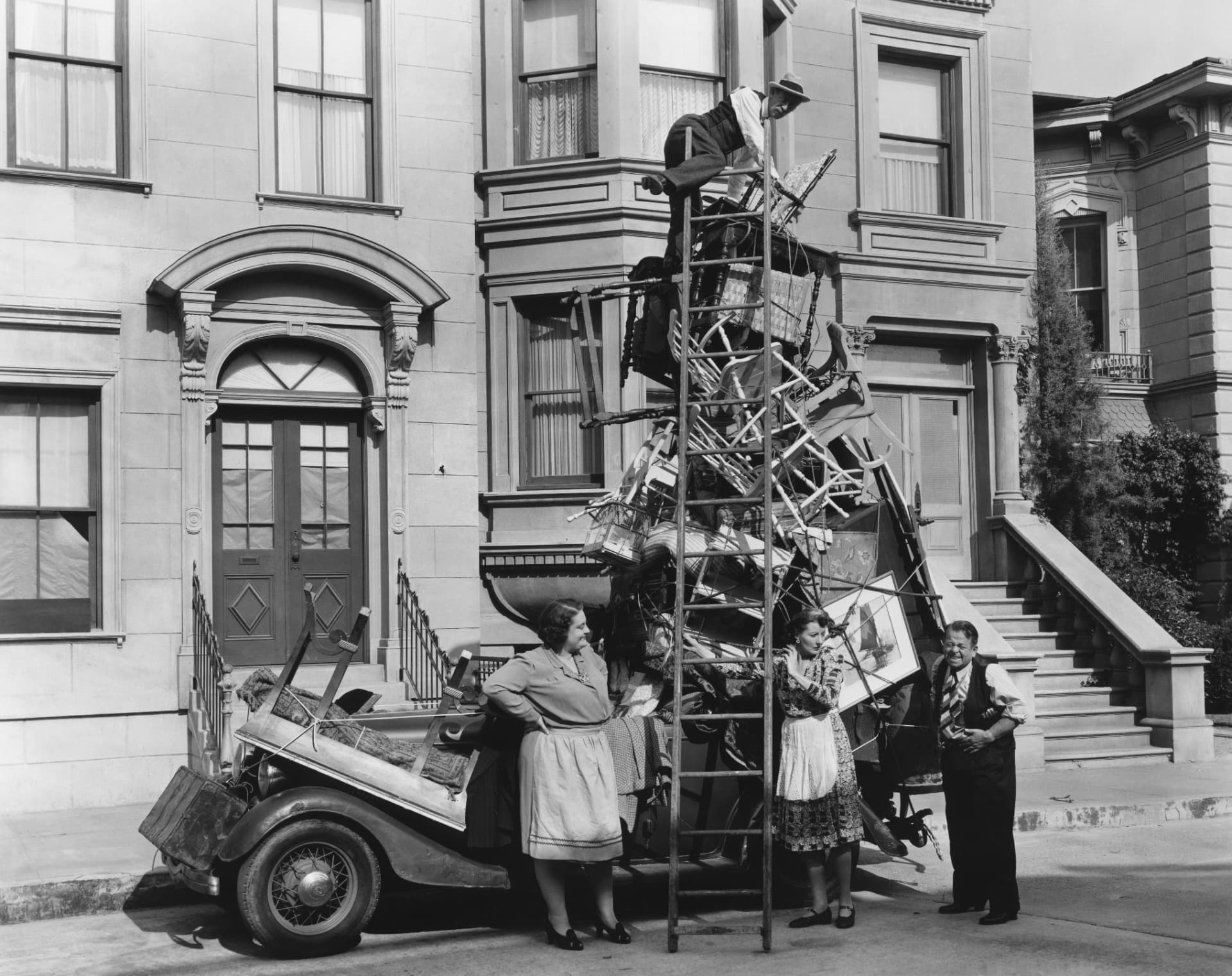 A team beside an overloaded vehicle